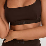 Introducing our Ribbed Strappy Bralet in chocolate - the perfect blend of style and comfort. Made with breathable Lyocel, cotton, and spandex, this seamless bralet offers soft support and a flattering scoop neckline. The 2-way adjustable straps allow for a customised fit, making it ideal for lounging and layering. Elevate your everyday look with its sophisticated ribbed texture.