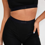 Our Ribbed Boxer in Black is the ideal choice for those seeking more coverage. With its high-rise waist and comfortable, full-coverage design, this boxer is sure to become a staple in your collection. The ribbed fabric provides a tailored fit while the elastic waistband, adorned with our signature logo, ensures a secure, all-day hold. Whether you're relaxing at home or getting ready for bed, these boxers offer unmatched comfort.