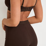 Introducing our Ribbed Strappy Bralet in chocolate - the perfect blend of style and comfort. Made with breathable Lyocel, cotton, and spandex, this seamless bralet offers soft support and a flattering scoop neckline. The 2-way adjustable straps allow for a customised fit, making it ideal for lounging and layering. Elevate your everyday look with its sophisticated ribbed texture.