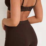 Introducing our Ribbed Strappy Bralet in chocolate - the perfect blend of style and comfort. Made with breathable Lyocel, cotton, and spandex, this seamless bralet offers soft support and a flattering scoop neckline. The 2-way adjustable straps allow for a customised fit, making it ideal for lounging and layering. Elevate your everyday look with its sophisticated ribbed texture.