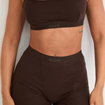 Introducing our Ribbed Strappy Bralet in chocolate - the perfect blend of style and comfort. Made with breathable Lyocel, cotton, and spandex, this seamless bralet offers soft support and a flattering scoop neckline. The 2-way adjustable straps allow for a customised fit, making it ideal for lounging and layering. Elevate your everyday look with its sophisticated ribbed texture.