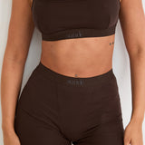 Introducing our Ribbed Strappy Bralet in chocolate - the perfect blend of style and comfort. Made with breathable Lyocel, cotton, and spandex, this seamless bralet offers soft support and a flattering scoop neckline. The 2-way adjustable straps allow for a customised fit, making it ideal for lounging and layering. Elevate your everyday look with its sophisticated ribbed texture.