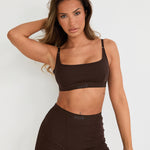 Introducing our Ribbed Strappy Bralet in chocolate - the perfect blend of style and comfort. Made with breathable Lyocel, cotton, and spandex, this seamless bralet offers soft support and a flattering scoop neckline. The 2-way adjustable straps allow for a customised fit, making it ideal for lounging and layering. Elevate your everyday look with its sophisticated ribbed texture.