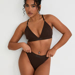 Pair your bralet with our matching Cotton Lyocel Ribbed Thong for a complete look of effortless elegance. The thong offers minimal coverage with maximum comfort, featuring the same soft and breathable fabric blend. The ribbed texture and sleek design ensure a smooth fit under any garment, while the elastic waistband with our signature logo provides a secure yet gentle hold.