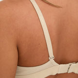 Elevate your style and comfort with our Latte Ribbed Triangle Bralet. Enjoy gentle yet effective support, a triangular neckline, and adjustable 2-way straps for a personalised fit. This seamless bralet boasts a smooth profile under any outfit, thanks to its ribbed design and blend of Lyocell, cotton, and spandex. Perfect for lounging or layering, this essential garment offers both long-lasting comfort and sophisticated appeal, making it a must-have for any fashion-forward wardrobe.