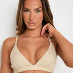Elevate your style and comfort with our Latte Ribbed Triangle Bralet. Enjoy gentle yet effective support, a triangular neckline, and adjustable 2-way straps for a personalised fit. This seamless bralet boasts a smooth profile under any outfit, thanks to its ribbed design and blend of Lyocell, cotton, and spandex. Perfect for lounging or layering, this essential garment offers both long-lasting comfort and sophisticated appeal, making it a must-have for any fashion-forward wardrobe.