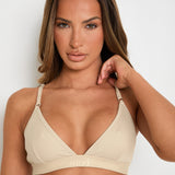 Elevate your style and comfort with our Latte Ribbed Triangle Bralet. Enjoy gentle yet effective support, a triangular neckline, and adjustable 2-way straps for a personalised fit. This seamless bralet boasts a smooth profile under any outfit, thanks to its ribbed design and blend of Lyocell, cotton, and spandex. Perfect for lounging or layering, this essential garment offers both long-lasting comfort and sophisticated appeal, making it a must-have for any fashion-forward wardrobe.