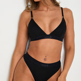 Pair your bralet with our matching Cotton Lyocel Ribbed Thong for a complete look of effortless elegance. The thong offers minimal coverage with maximum comfort, featuring the same soft and breathable fabric blend. The ribbed texture and sleek design ensure a smooth fit under any garment, while the elastic waistband with our signature logo provides a secure yet gentle hold.